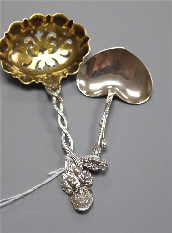 A Tiffany & Co sterling silver heart-shaped caddy spoon and a Tiffany strawberry sifter spoon